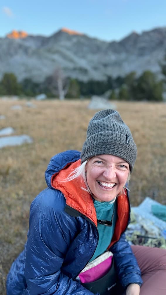 Photo of Katy laughing sitting on the ground